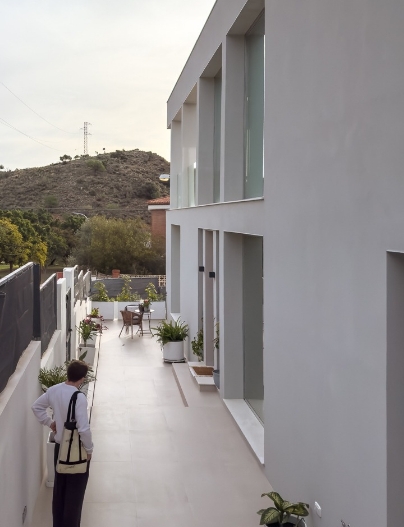 Fachada de vivienda minimalista blanca con puerta de acceso